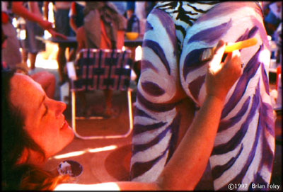 Roger having his butt painted by Katherine.